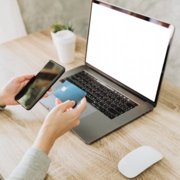 person checking phone and laptop